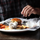 Illustration for article titled Diner Who Previously Put Wadded-Up Napkin On Center Of Plate Comes Out Of Retirement To Take One Last Stab At Burger